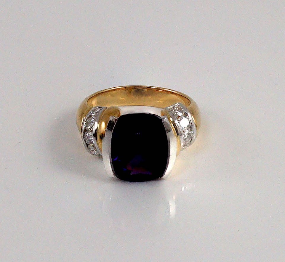 A modern 18ct gold and single stone cushion cut amethyst set dress ring, with ten stone diamond set shoulders